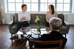 man-in-white-dress-shirt-sitting-on-gray-couch